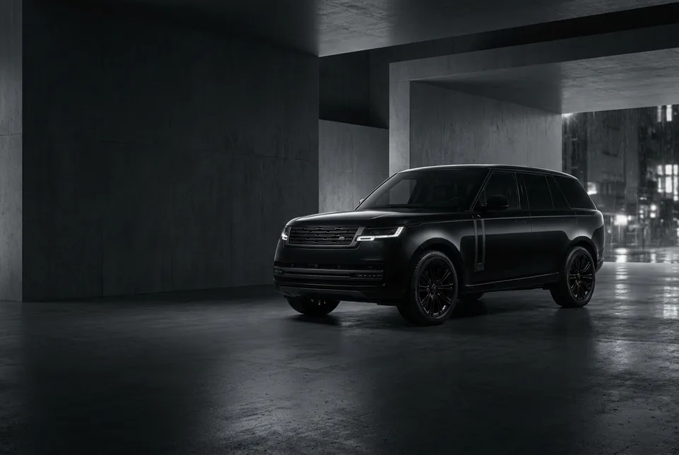 Black luxury SUV in a dark architectural space